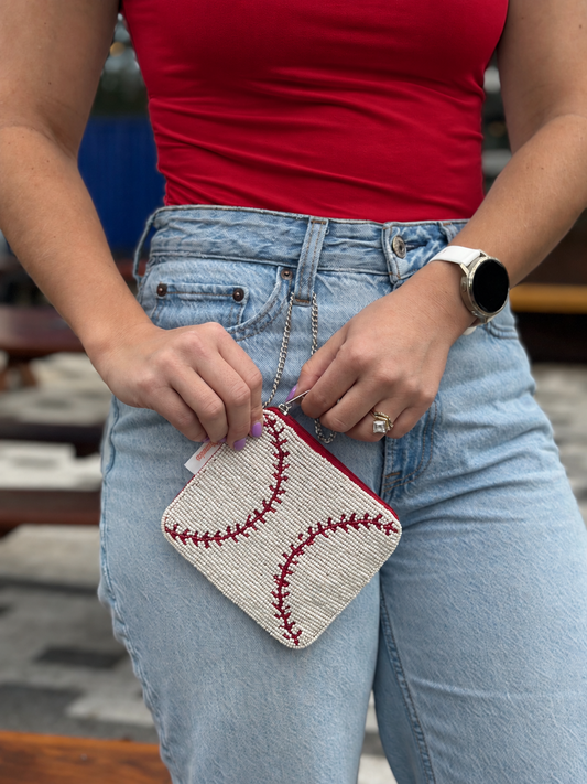 White and red baseball stitch beaded coin purse styled with red shirt and jeans