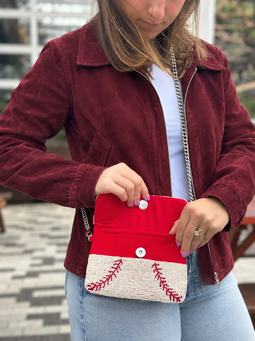 White and red baseball stitch beaded clutch shown open
