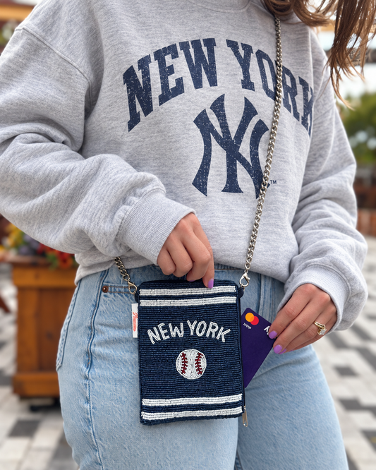 NEW YORK navy baseball beaded cell phone crossbody styled with an oversized gray New York crewneck
