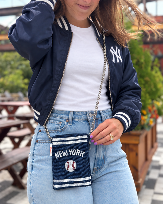 NEW YORK navy baseball beaded cell phone crossbody styled with a white tee and navy jacket