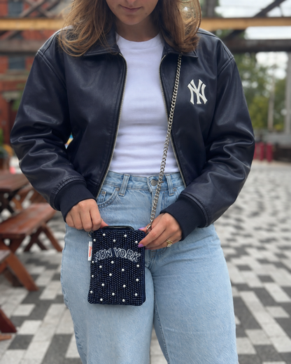 NEW YORK beaded cell phone crossbody styled with a navy leather jacket and white tee
