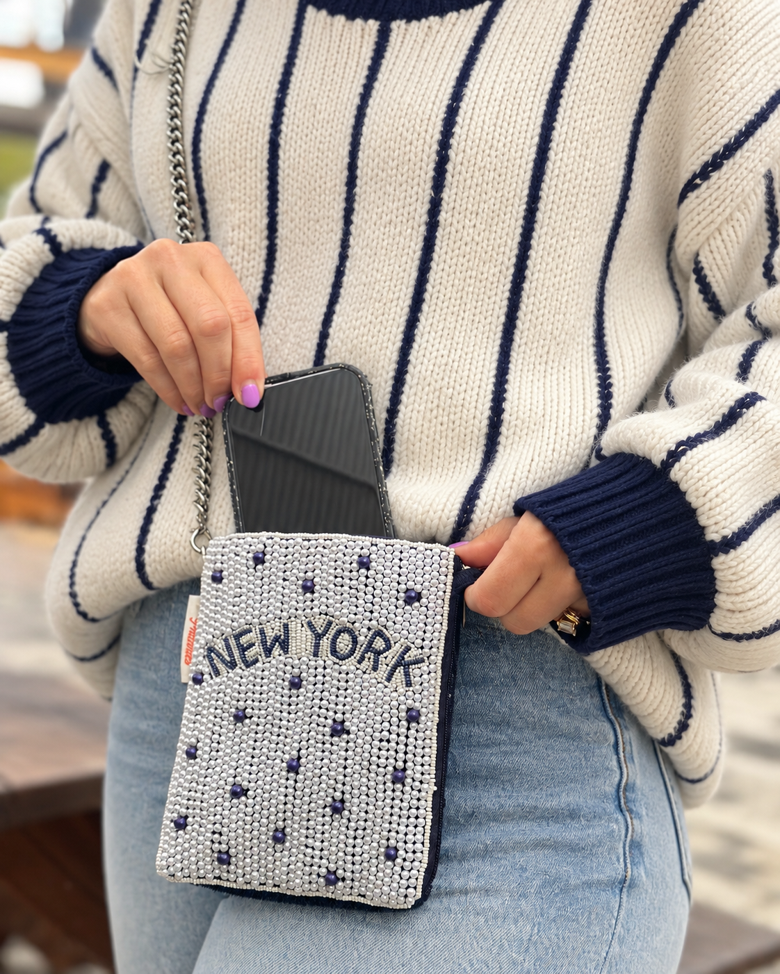 NEW YORK white and navy dot beaded cell phone crossbody styled with cream navy striped sweater