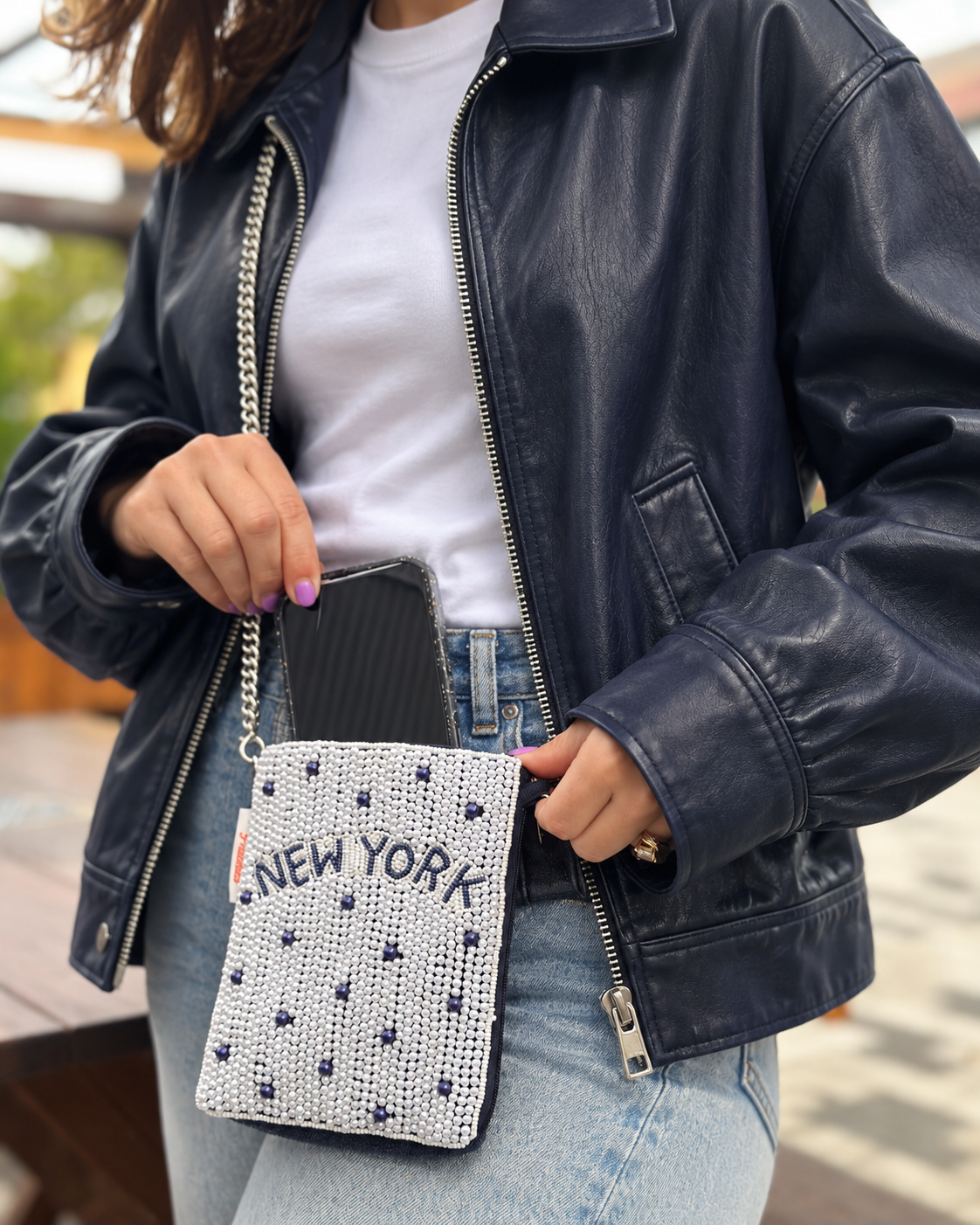 NEW YORK white and navy dot beaded cell phone crossbody styled with navy leather jacket