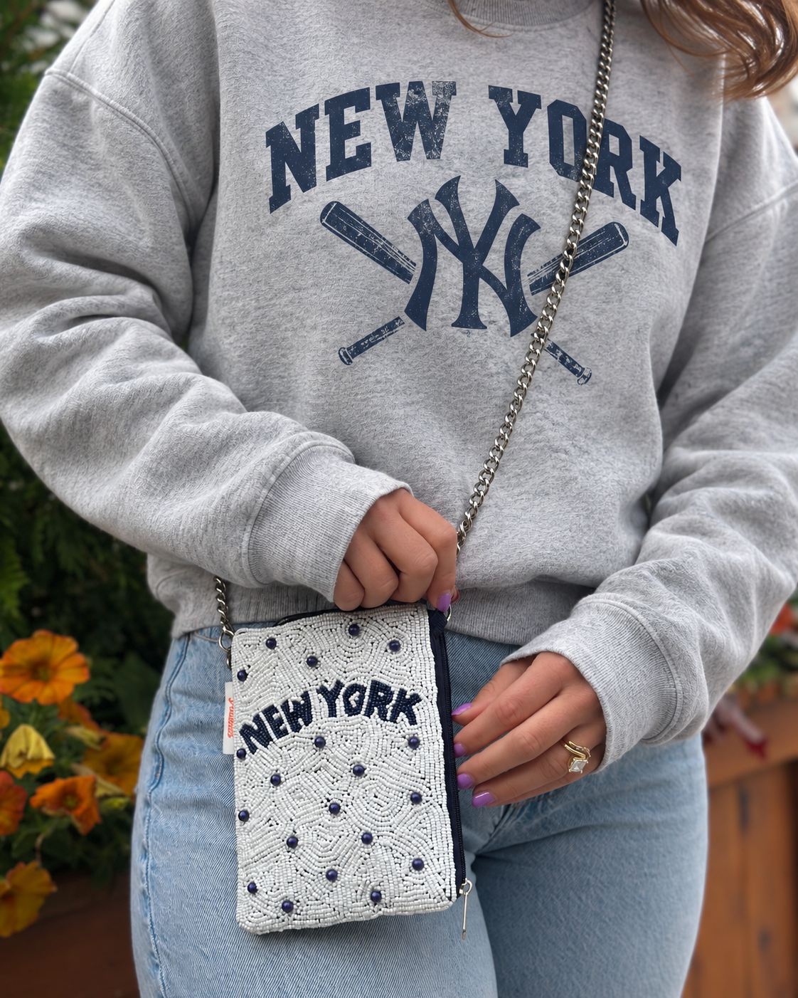 NEW YORK white and navy beaded cell phone crossbody styled with gray crewneck