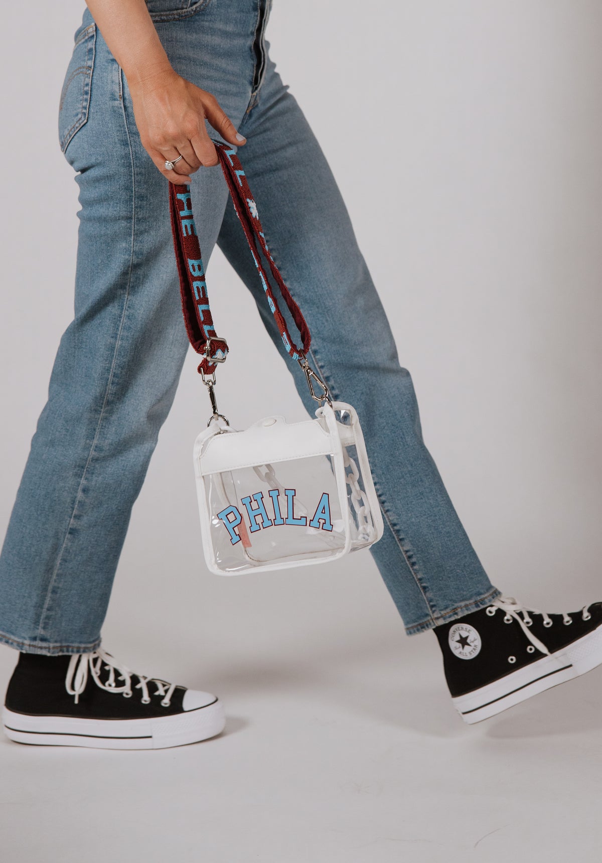 White PHILA clear crossbody bag with burgundy and powder blue RING THE BELL strap