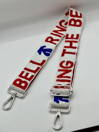 White beaded RING THE BELL strap with red lettering