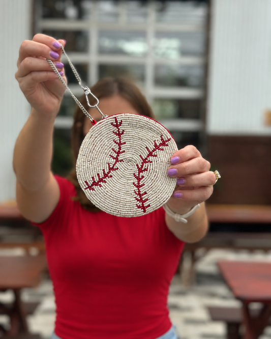 Round white and red baseball beaded coin purse held up by chain