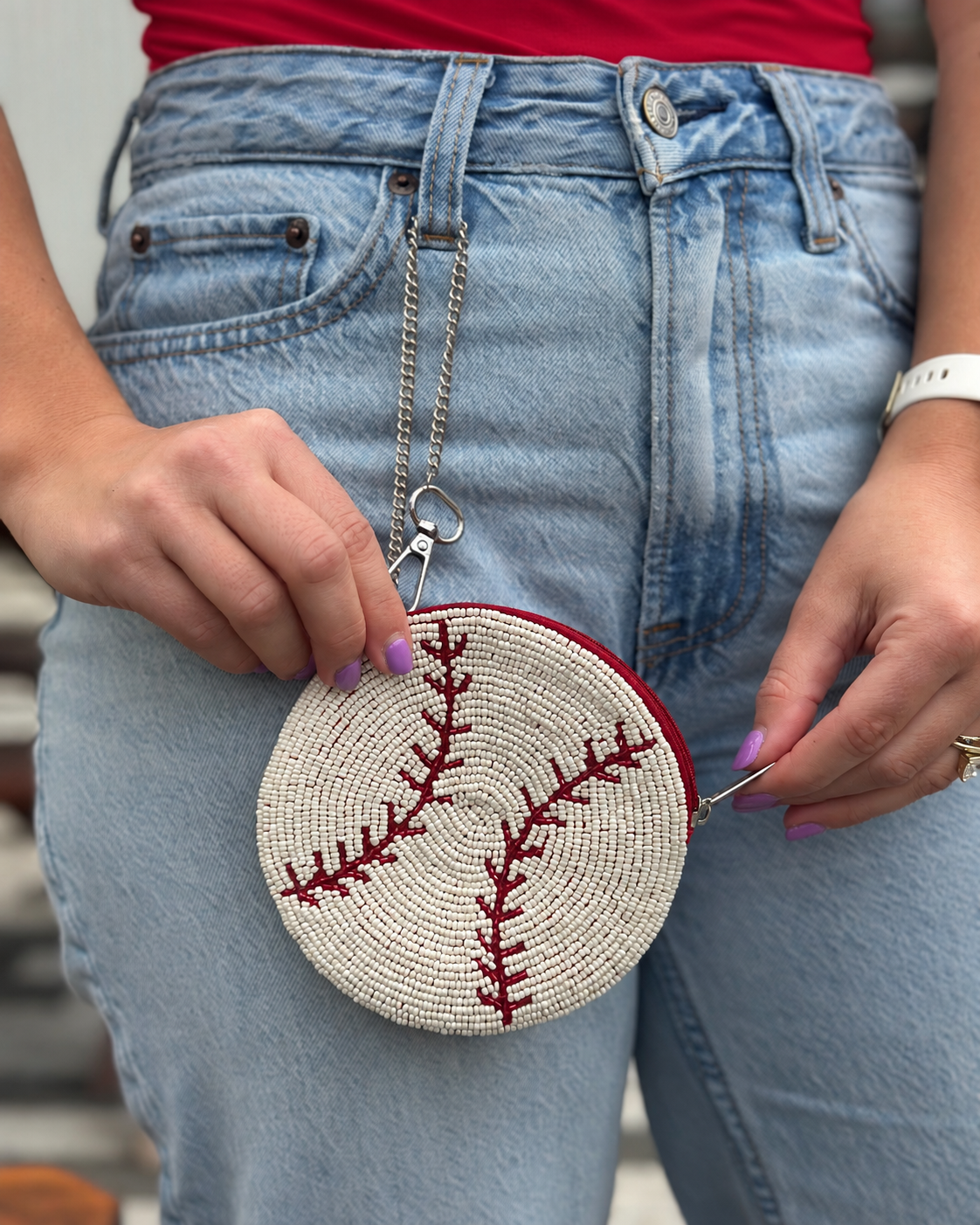 Close-up of round white and red baseball beaded coin purse